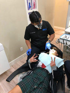 Dr. Reyes performing emergency dentist services on a client who had a chipped tooth. 