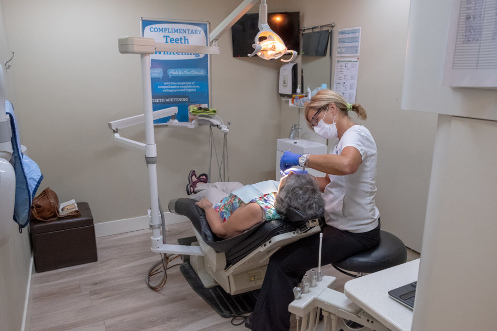 Patient receiving teeth whitening from the menu of cosmetic dentistry services at North Shores Dental in Toronto, ON.