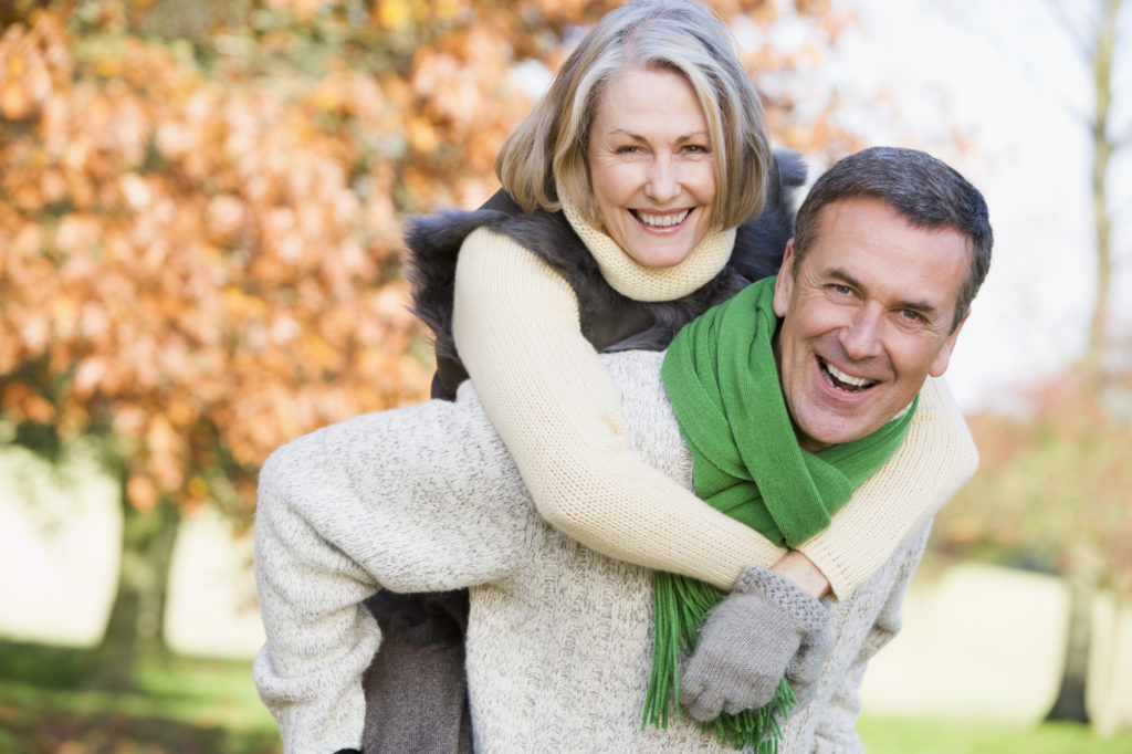 Senior couple are active and happy knowing they have effective and permanent dental implants to make their life easier. 